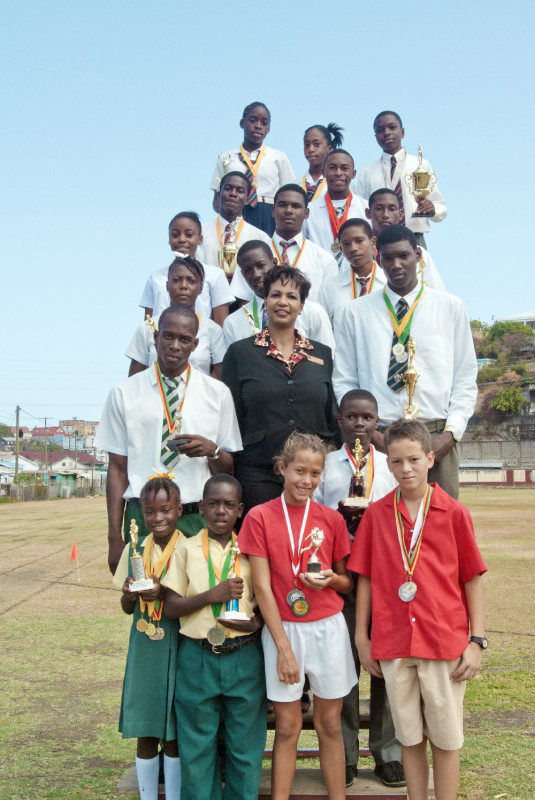 Winners podium showing CARIFTA athletes and winners from other schools with CIBC FirstCaribbean representative, Marlene Lander