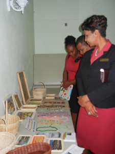 CIBC FirstCaribbean representative and guests viewing and purchasing craft made by persons with disabilities 