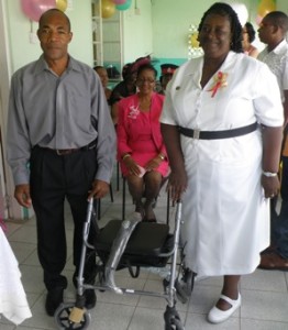 President of Calabash Promotions presents Rollator to nurse in charge of the home