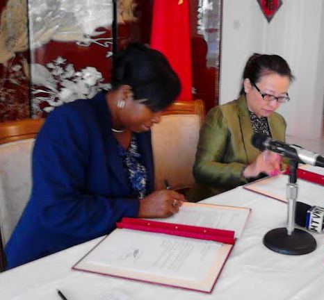 Youth Minister Emmalin Pierre and Chinese Amb Madam Ou Boqian signing the agreement for the financial assistance