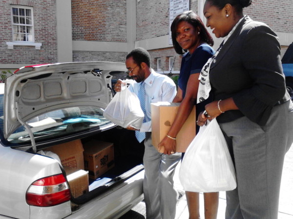 NIDCU rep packing groceries donated into vehicle