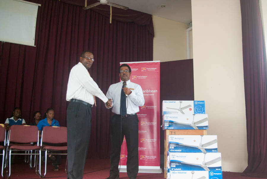 CIBC FirstCaribbean Country Manager Nigel Ollivierre Presents Fans to School Principal Phillip Thomas