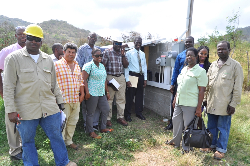 Employees of the Ministry of Carriacou and Petite Martinique Affairs along with workers of GRENLEC at the connecting of the  solar system