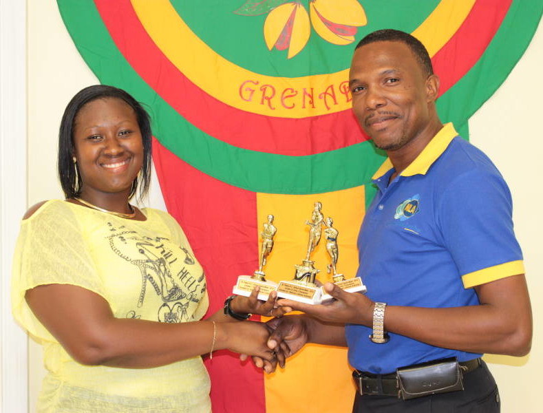 NLA’s Marketing & Business Development Assistant – Mr Amilcar George handing over Trophies to Representative from St Peter’s RC School