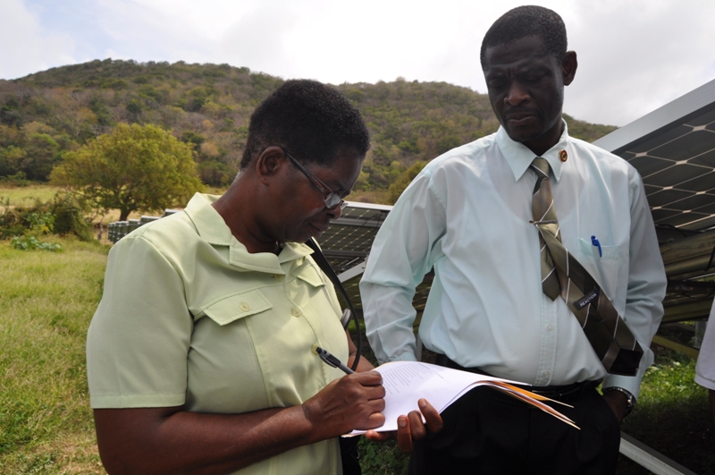 Senior Administrative Officer Marie Alexis signs agreement with GRENLEC 