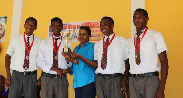SCHN and EMP Manager Allyson Clouden presenting inaugural Immunization Road Relay Trophy to Male Division Winners Grenada Boys Secondary School
