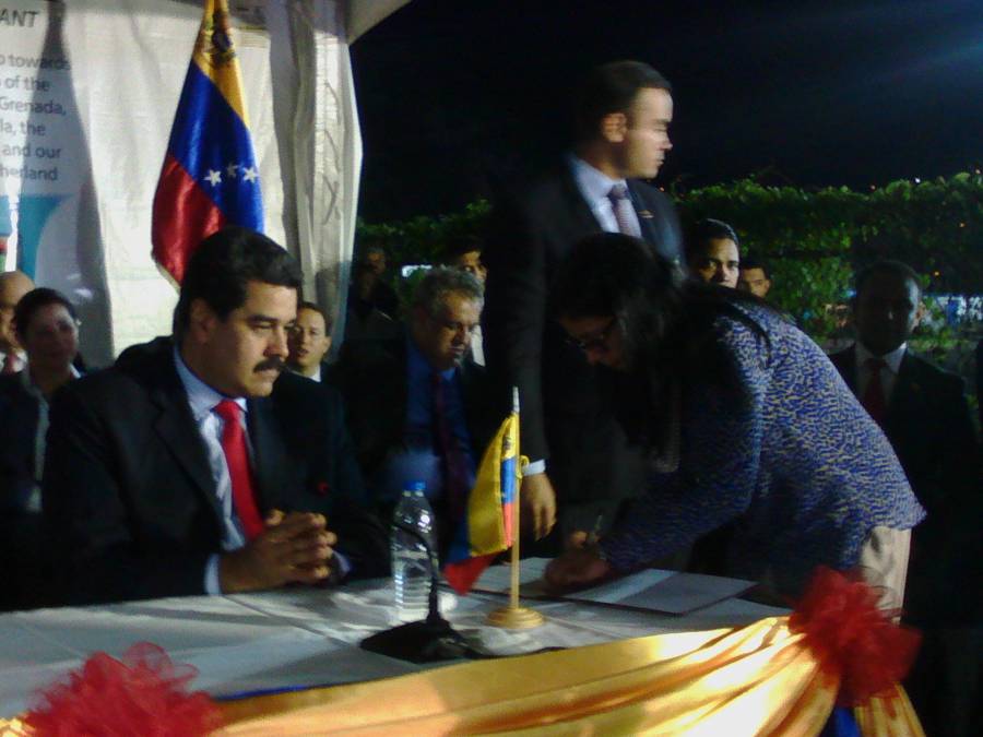 Maduro watching while his minister signs the miracle eyes programme agreement