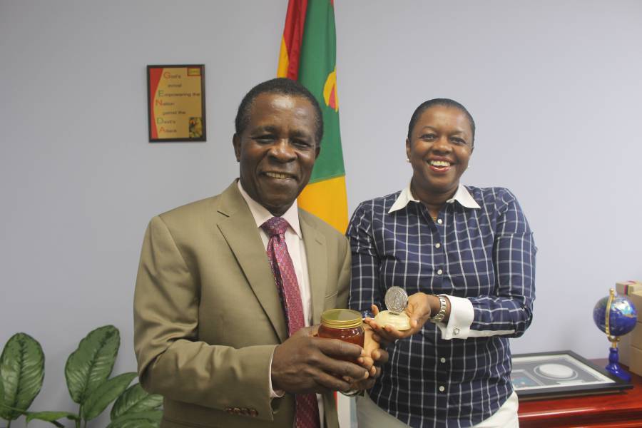 Prime Minister Dr. the Right Honourable Keith Mitchell, as he was presented with dozens of jars of the award-winning honey by Dr. Valma Jessamy, who is herself holding the Medal of Ukraine which the team won for the “best honey in the world.”