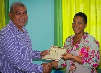 A participant receiving her certificate following completing of the training course