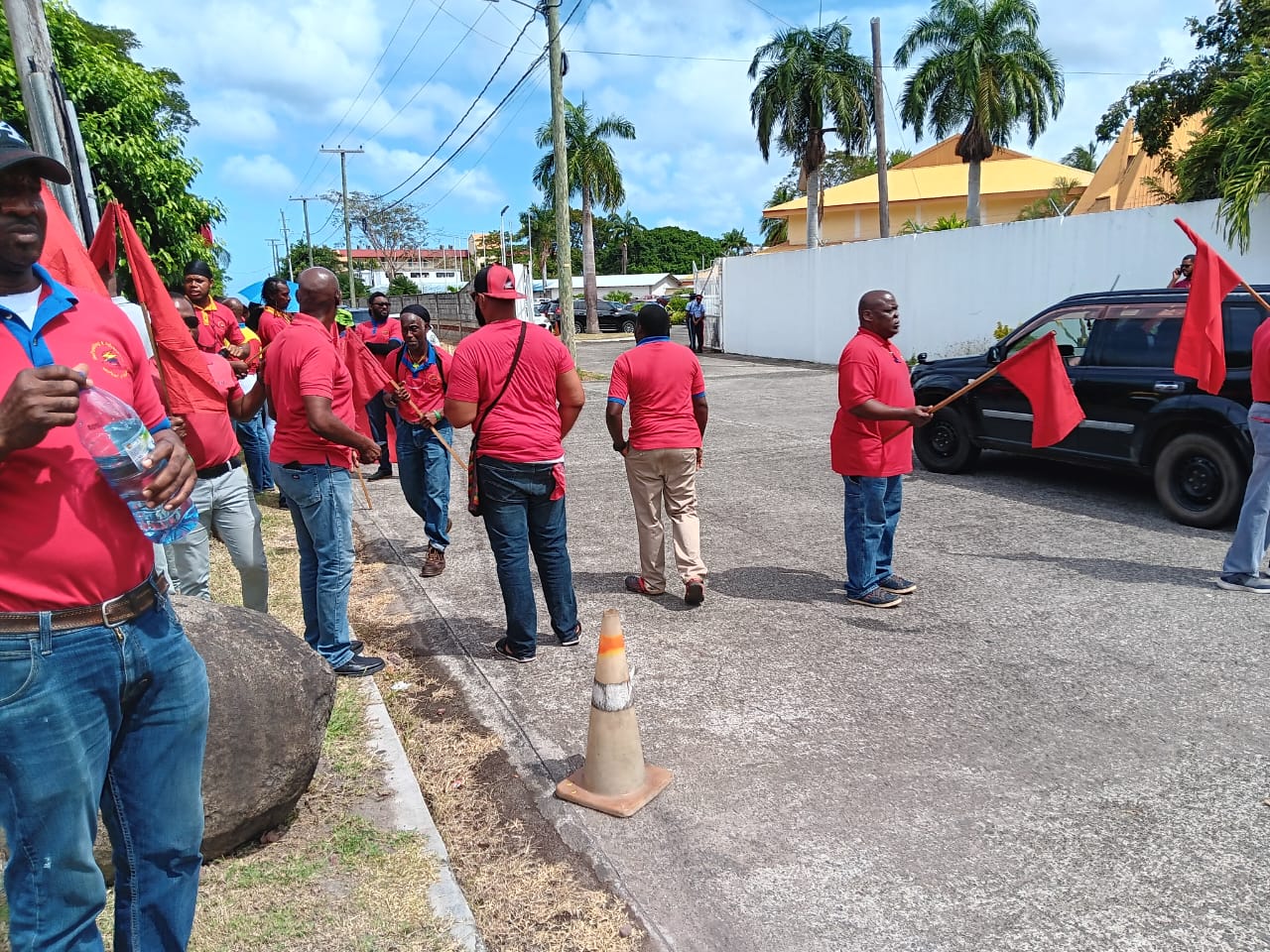 Striking workers protesting at entrance to OECS Migration ministers meeting